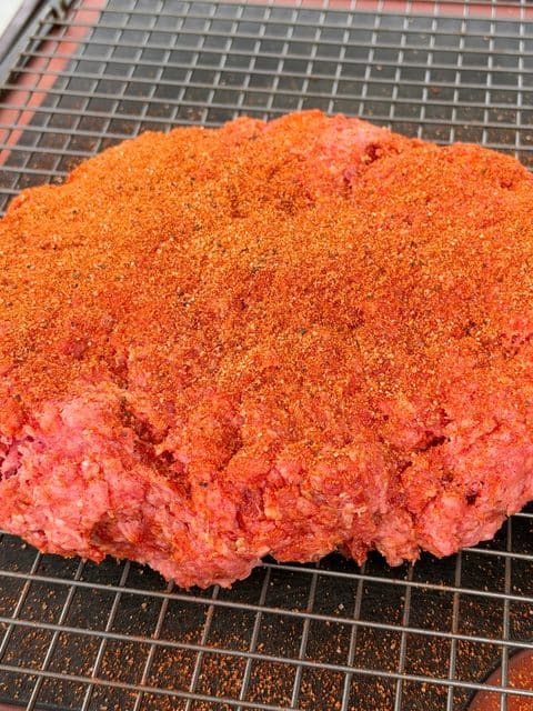 Wide ground chuck and Italian sausage loaf coated with BBQ seasoning for Smoked Over the Top Chili.